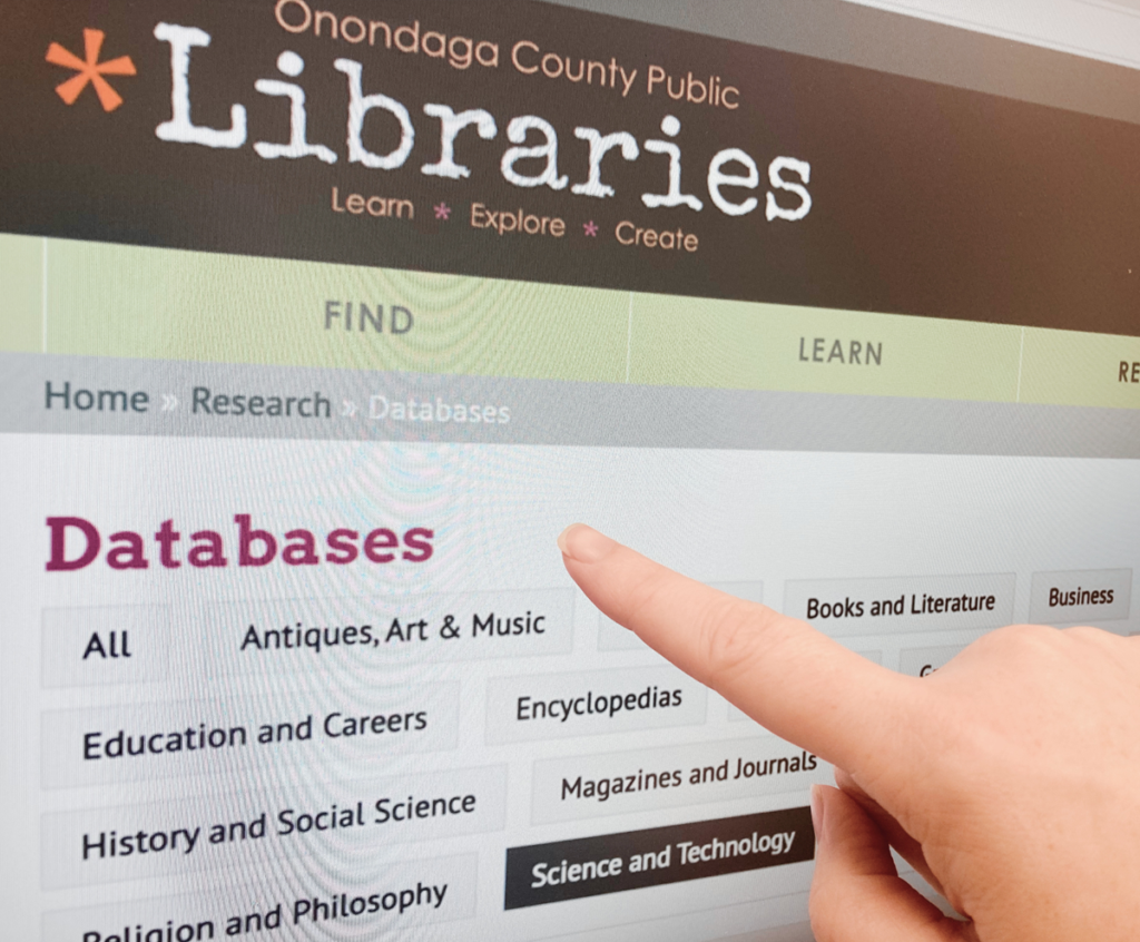 photo of a finger pointing at the database page of the Onondaga County Public Libraries website